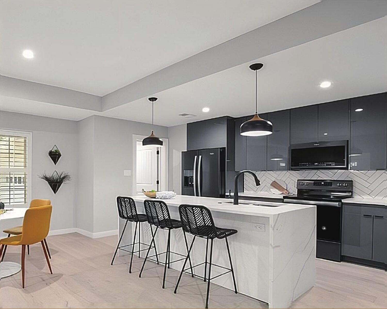Modern handleless kitchen in charcoal gloss with a marble waterfall island